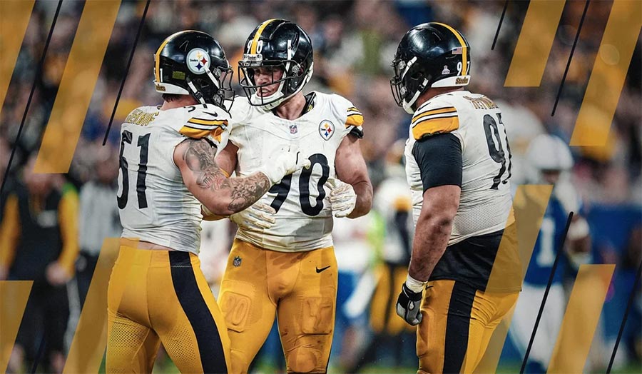 Three defensive football players huddling together, showing unity and strategy before the play