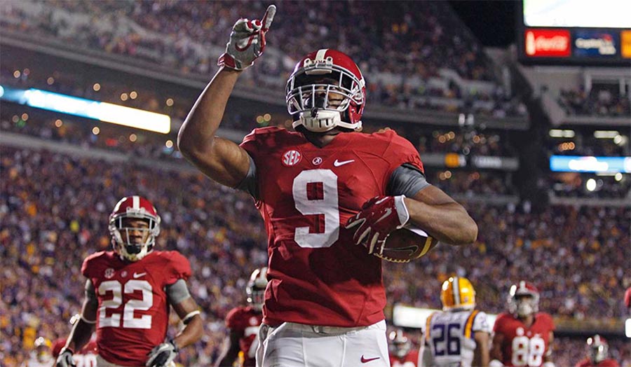 Amari Cooper holding the football after a reception at Alabama