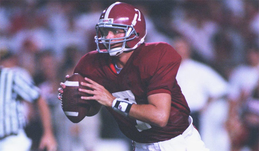 Jay Barker throwing a pass in Alabama Crimson Tide colors