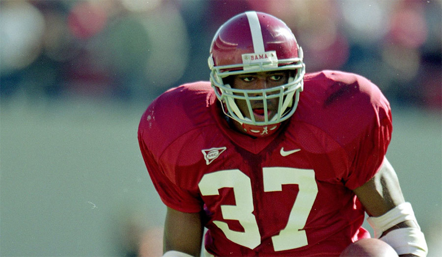 Shaun Alexander running with the football for Alabama